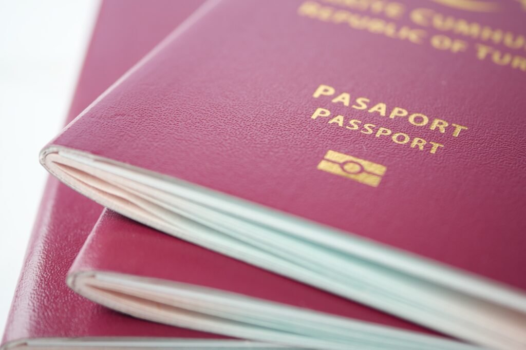 stack of red color passport on table